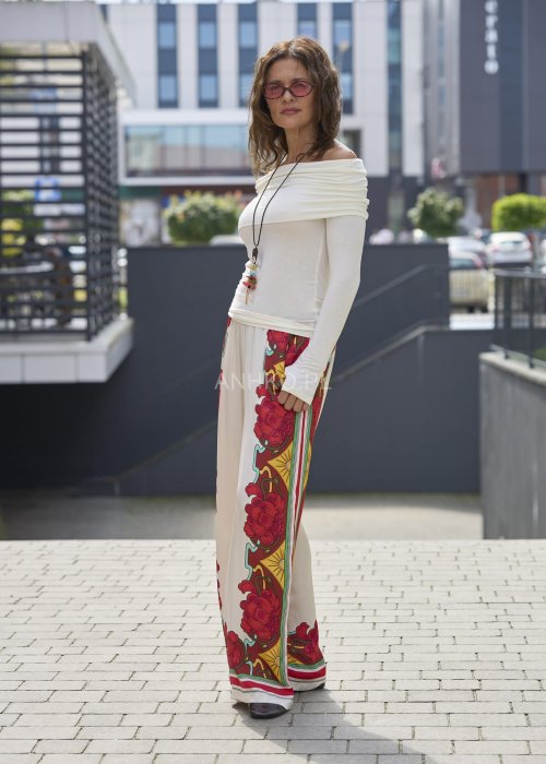 Szerokie spodnie damskie z lekkiego materiału w kolorze ecru z czerwonym kwiatowym i geometrycznym printem boho