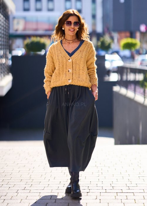 Żółty kardigan damski z grubym splotem, zapinany na duże guziki, o krótszym kroju i luźnym fasonie, styl casual boho