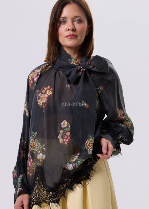 Czarna bluzka Liora Bloom w kwiaty z koronkowym wykończeniem, luźny fason, wiązanie przy szyi i długie rękawy, styl boho elegancki.