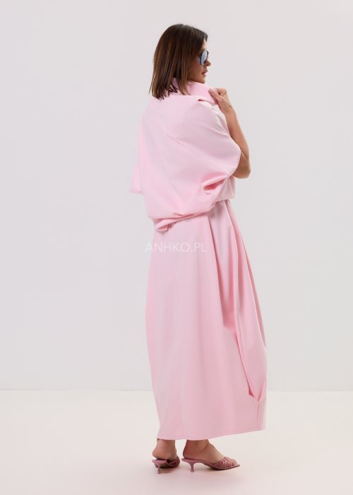 Różowa spódnica maxi o luźnym, nowoczesnym kroju z elastyczną gumką w pasie i miękko układającą się tkaniną, prezentowana na modelce w minimalistycznej stylizacji.