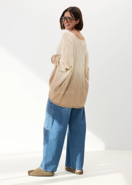 Beżowy sweter oversize o luźnym kroju z delikatnym tłoczonym wzorem i szerokim dekoltem. Miękki model idealny do codziennych stylizacji z jeansami lub spodniami wide leg.