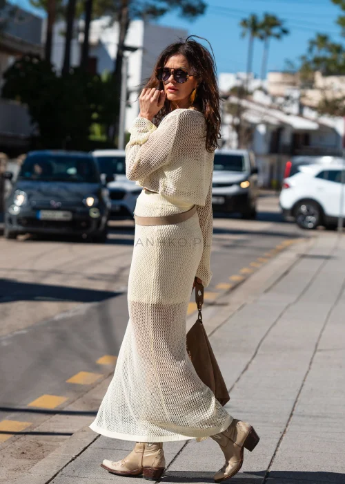 Śmietankowa ażurowa spódnica Crop maxi z siateczkowym splotem i krótszą podszewką. Lekko transparentny fason tworzy elegancką stylizację w stylu boho.